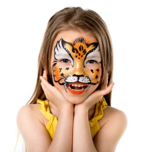 cute little girl with colorful painted face like tiger